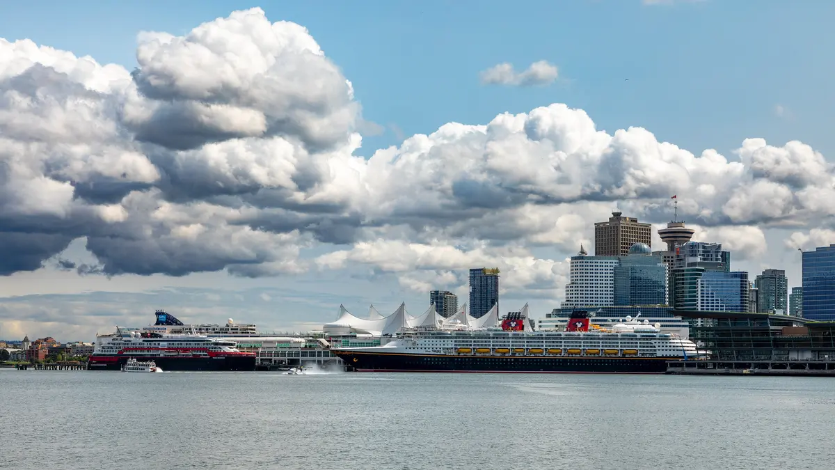 Canada Place sails and the downtown skyline under big clouds